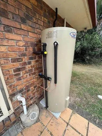 New tank water heater installation with insulated pipes at a Yorba Linda home