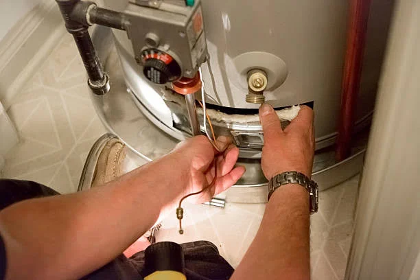 Local plumber repairing a gas water heater in a Yorba Linda home